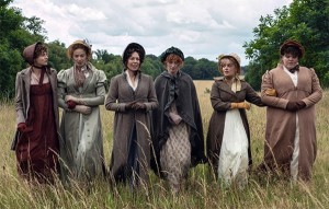 Bennet sisters and Mrs. Bennet walking through a field in the Netflix adaptation of Pride and Prejudice.
