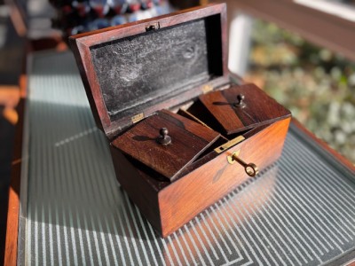 Tea caddy open to reveal two lidded compartments